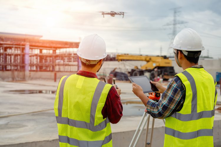 Drone operated by construction worker on building site,flying wi